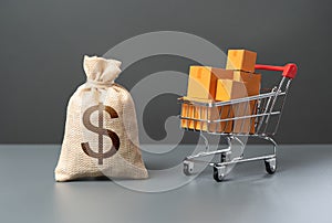 Supermarket cart with boxes of goods and dollar money bag