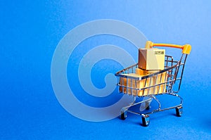 Supermarket cart with boxes, merchandise. the concept of buying and selling goods and services, internet commerce, online shopping