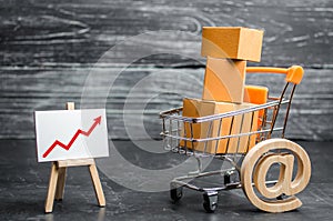 A supermarket cart loaded with lots of boxes and a red up arrow. Online sales and e-commerce, product and brand promotion. concept