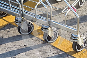 Supermarket cart wheels, close-up.