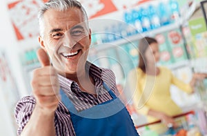 Supermarket clerk giving a thumbs up