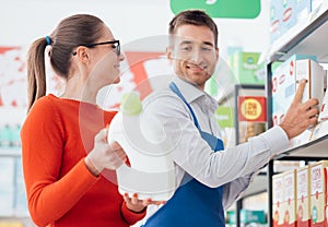 Supermarket clerk helping a customer