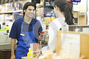 Supermarket Employee Assisting Female Customer