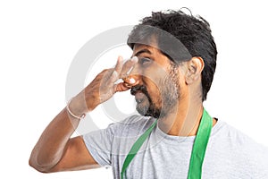 Supermarket employee holding nose