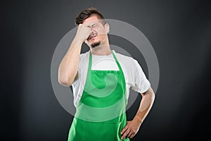 Supermarket employer standing acting tired