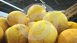 At the supermarket: gliding shot of the fresh produce section of the store. Exotic fruits and organic vegetables on sale