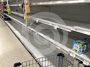 Supermarket isle of bottled water is sold out at a local grocery