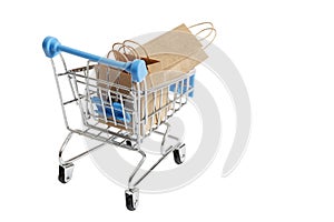 Supermarket shopping cart with paper shopping bags