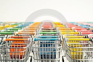 Supermarket shopping carts on light background. Online shopping, sales, Black Friday sale concept. A lot of shopping mall trolleys