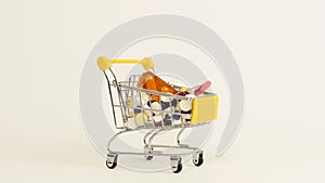 Supermarket trolley filled with medical capsules on a white background