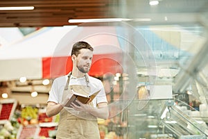 Supermarket Worker doing Inventory