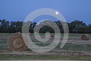Supermoon over hay bales photo