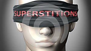 Superstitions can make us blind - pictured as word Superstitions on a blindfold to symbolize that it can cloud perception, 3d