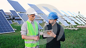 Supervising engineer with a worker who reads the construction plan.