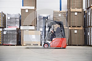 Supervisor Driving Forklift In Warehouse