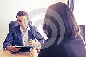 Supervisor explaining documents contractto a female worker photo