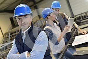 Supervisor in an industrial factory with employees photo