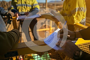 Supervisor issuing confined space permit on the field