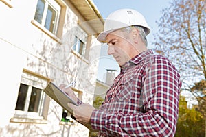 Supervisor looking at clipboard outdoors