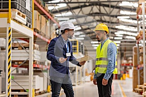 Supervisor, manager scolding employee in modern industry factory. Worker making mistake. Production manger is angry