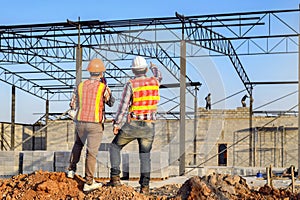 The supervisor is ordering the workers to complete the construction according to the plan