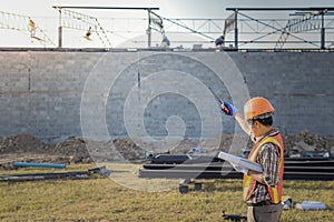 The supervisor is ordering the workers to complete the construction according to the plan