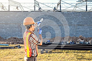 The supervisor is ordering the workers to complete the construction according to the plan