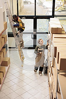 Supervisor scanning boxes barcode using store scanner