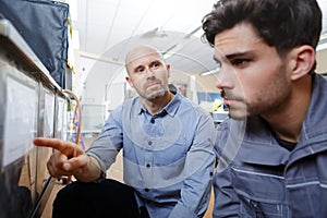 supervisor showing instructions to junior worker