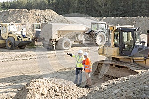 Supervisor showing something to colleague at construction site