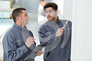 Supervisor talking to apprentice painter
