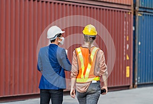 Supervisor and worker in the container yard, Industrial engineer and inspector or safety supervisor working in container terminal