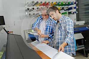supervisor and worker in industrial printing works