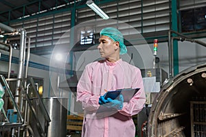 Supervisors supervising the process of beverage at the manufacturing . Man working in food Factory industry