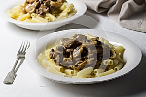 Supper plates with thick creamy mushroom and beef stroganoff on