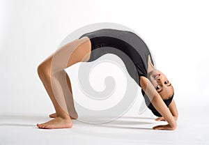 Supple girl bending backwards to form a bridge photo