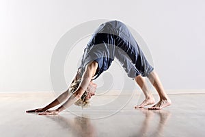 Supple young woman working out in a gym