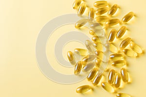 Daily supplement of evening primrose oil capsules on a yellow background