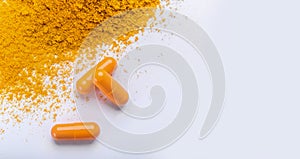 Supplement pills of curcumin or turmeric with a heap of the spice