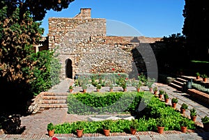 Supplier courtyard and gardens at the Nasrid Palace in Malaga castle.