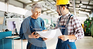 Supplier with engineer checking on production in factory