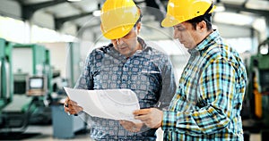 Supplier with engineer checking on production in factory