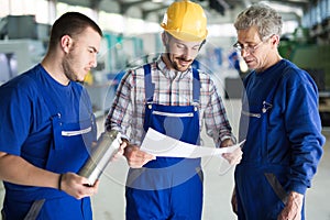 Supplier with engineer checking on production in factory