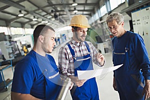 Supplier with engineer checking on production in factory