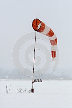 Supplies a wind sock on a background of grey sky