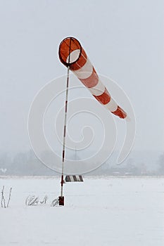 Supplies a wind sock on a background of grey sky
