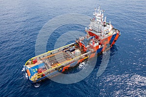 Supply boat comming to offload tool for offshore oil rig to compleation oil and gas well.