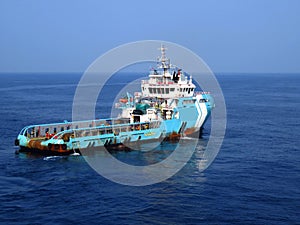 Supply boat crew boat transfer worker and cargo by personnel basket from platform to supply boat of oil and gas industry