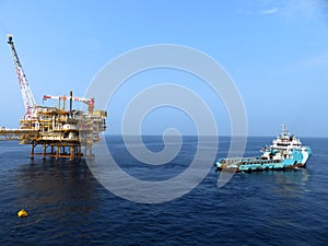 Supply boat crew boat transfer worker and cargo by personnel basket from platform to supply boat of oil and gas industry