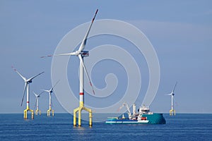 Supply boat with offshore wind turbine photo